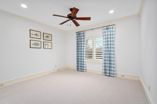 empty room with ceiling fan, ornamental molding, and carpet