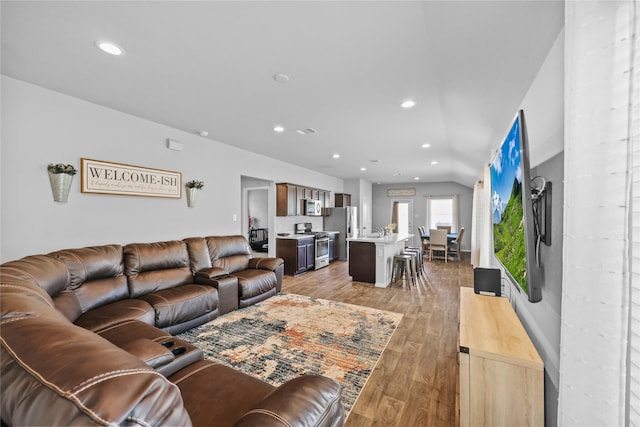 living room with lofted ceiling and hardwood / wood-style floors