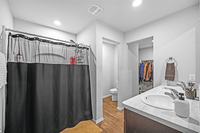 bathroom with toilet, vanity, hardwood / wood-style floors, and a shower with curtain