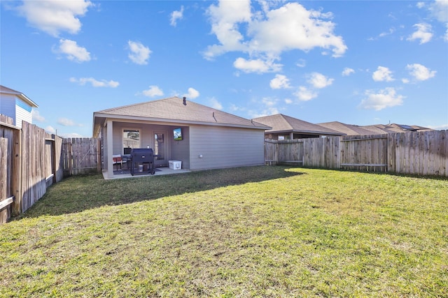 back of property with a patio area and a yard