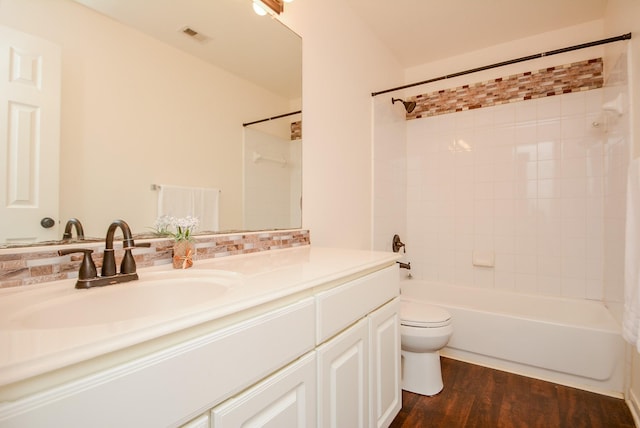 full bathroom featuring bathtub / shower combination, toilet, vanity, and hardwood / wood-style flooring