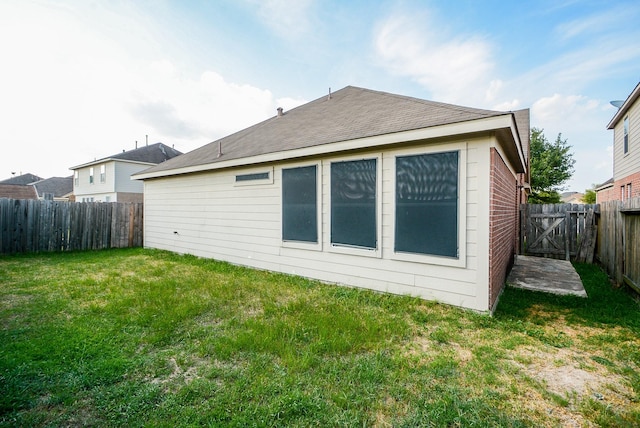 rear view of property with a lawn