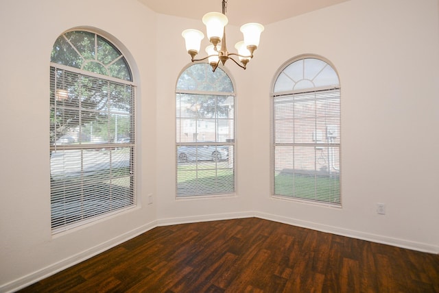 unfurnished dining area with a notable chandelier and hardwood / wood-style floors