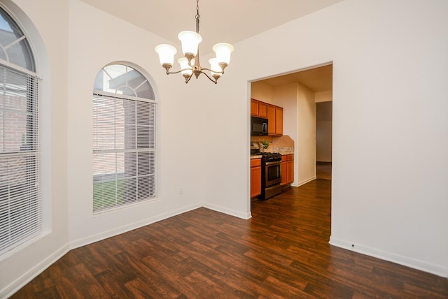 unfurnished dining area featuring an inviting chandelier and dark hardwood / wood-style floors