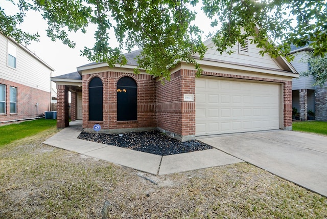 view of front of house with central AC unit and a garage