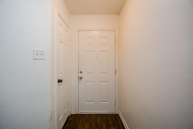 hall with dark hardwood / wood-style flooring