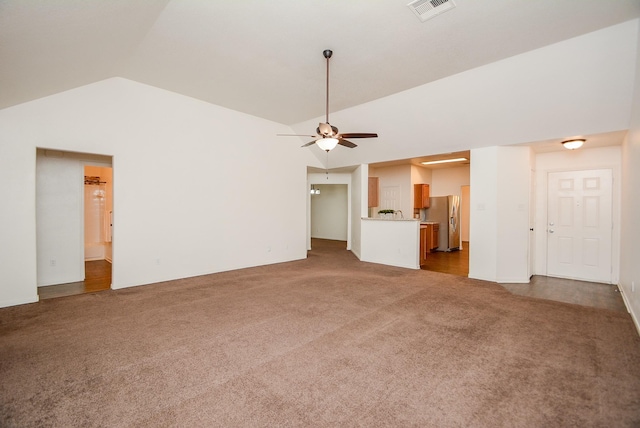 unfurnished living room featuring ceiling fan, vaulted ceiling, and light carpet