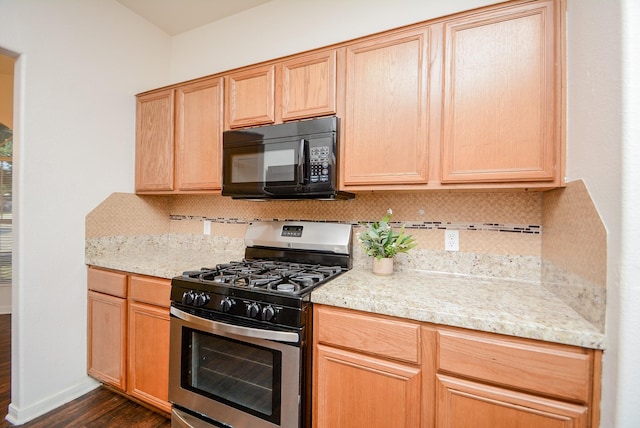 kitchen with backsplash, light brown cabinetry, stainless steel range with gas cooktop, and dark hardwood / wood-style floors