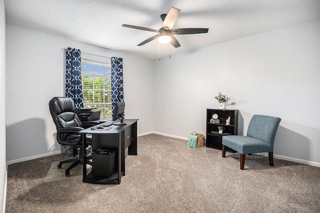 carpeted home office with ceiling fan and a textured ceiling