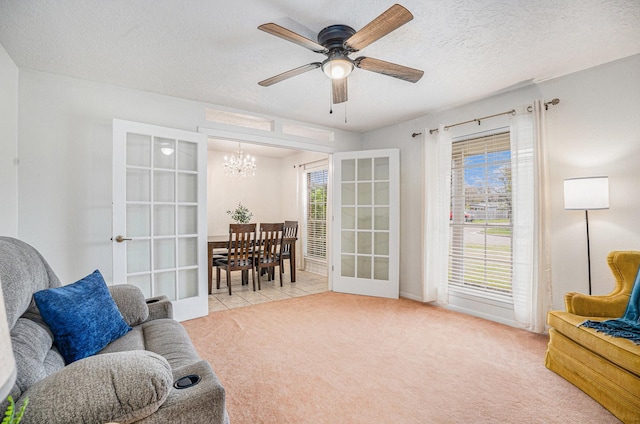 living area featuring light carpet, a healthy amount of sunlight, and french doors