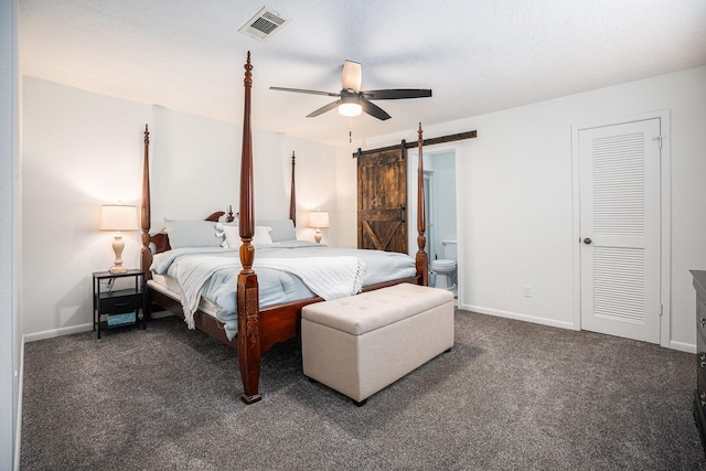 bedroom with ceiling fan, a barn door, and dark carpet