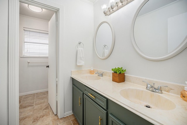 bathroom featuring ornamental molding and vanity