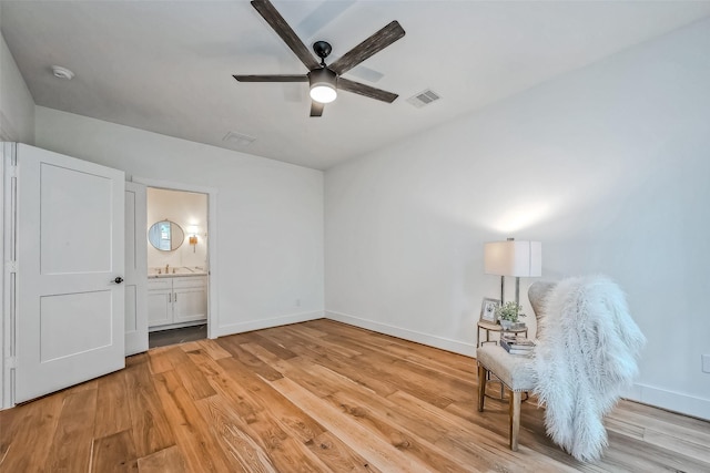 unfurnished room with ceiling fan, light hardwood / wood-style floors, and sink