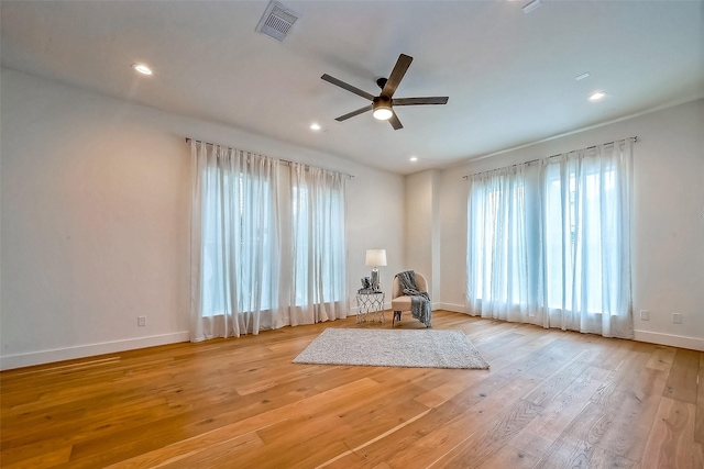 unfurnished room with ceiling fan and light hardwood / wood-style flooring