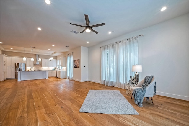 interior space with light wood-type flooring and ceiling fan