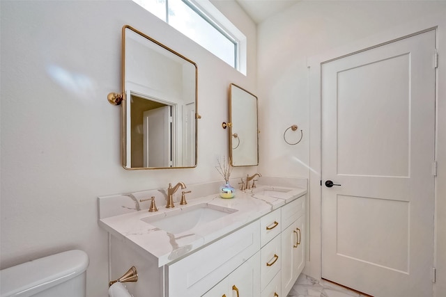 bathroom featuring toilet and vanity