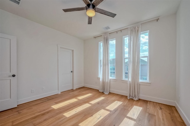 spare room featuring ceiling fan and light hardwood / wood-style flooring