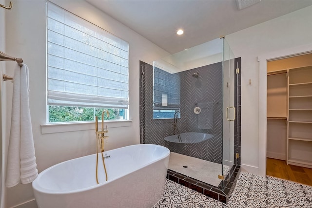 bathroom featuring plus walk in shower and tile patterned floors