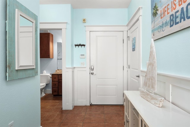 entrance foyer with dark tile patterned flooring