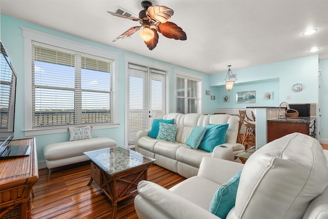 living room with ceiling fan, sink, and dark hardwood / wood-style flooring