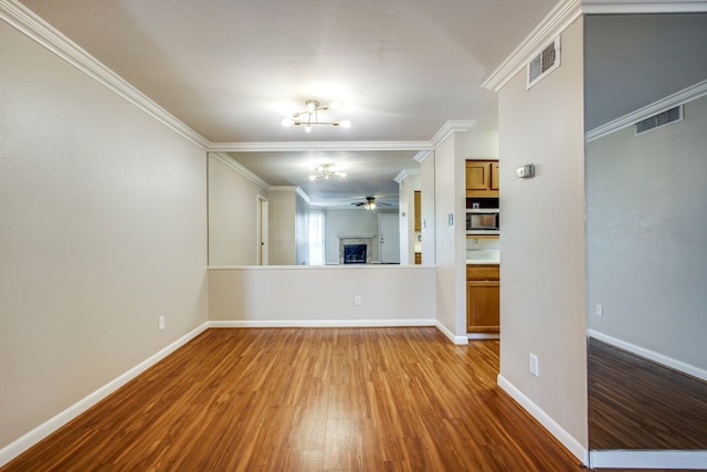 unfurnished room featuring hardwood / wood-style flooring, ornamental molding, and ceiling fan