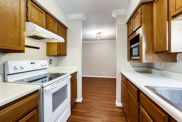 kitchen with dark wood-type flooring, ornamental molding, and white electric stove