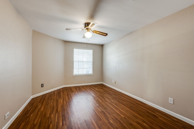 spare room with ceiling fan and dark hardwood / wood-style flooring