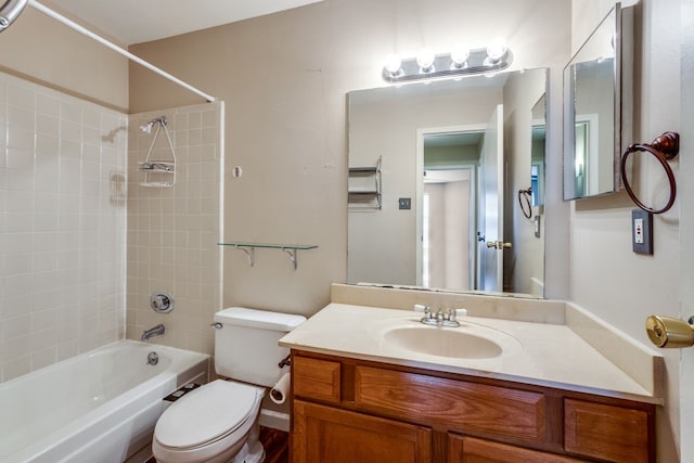 full bathroom with vanity, tiled shower / bath combo, and toilet