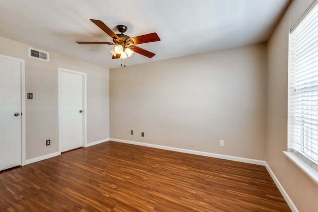 spare room featuring ceiling fan and dark hardwood / wood-style floors