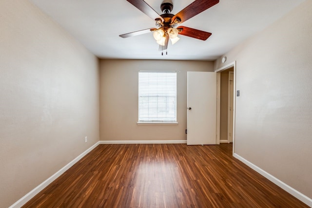 empty room with dark wood-type flooring and ceiling fan