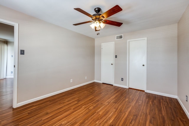 spare room with ceiling fan and dark hardwood / wood-style floors