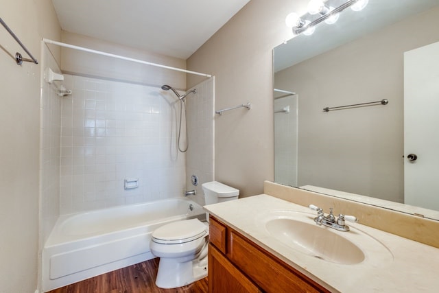 full bathroom with vanity, hardwood / wood-style flooring, shower / tub combination, and toilet