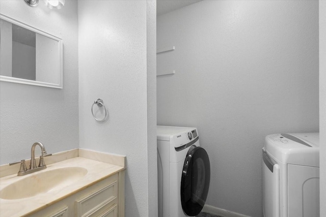 laundry room featuring sink and separate washer and dryer