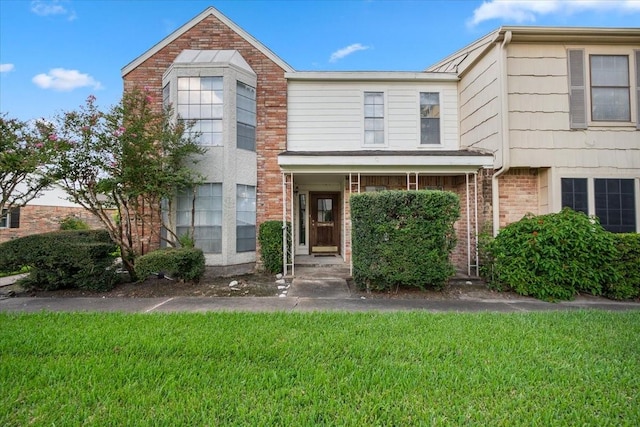 view of property with a front lawn and a porch