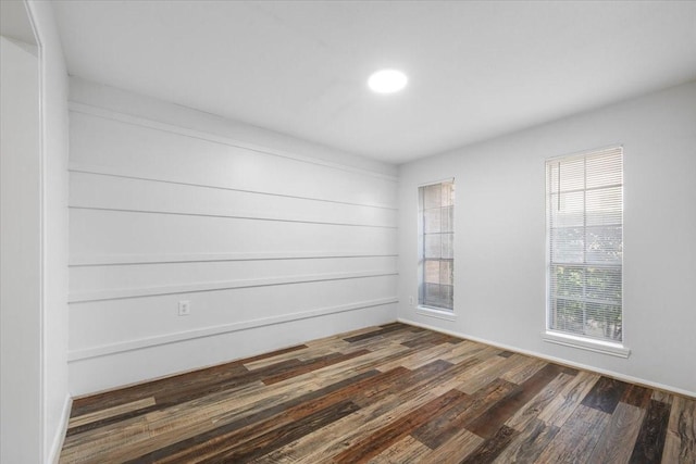 unfurnished room with dark hardwood / wood-style floors