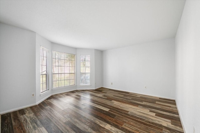 unfurnished room with dark hardwood / wood-style floors