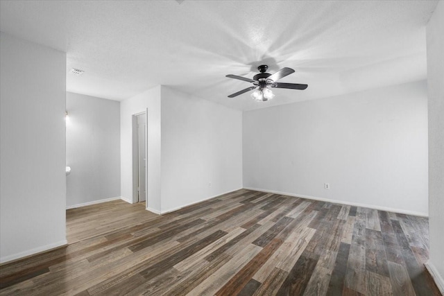 spare room featuring ceiling fan, a textured ceiling, and dark hardwood / wood-style floors