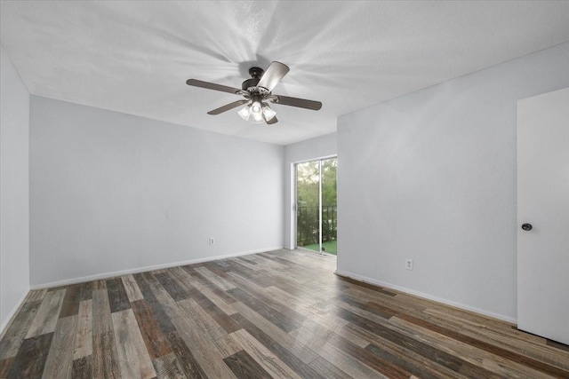 empty room featuring ceiling fan and dark hardwood / wood-style floors