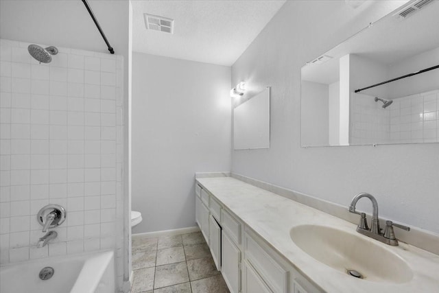 full bathroom with a textured ceiling, toilet, tiled shower / bath combo, and vanity