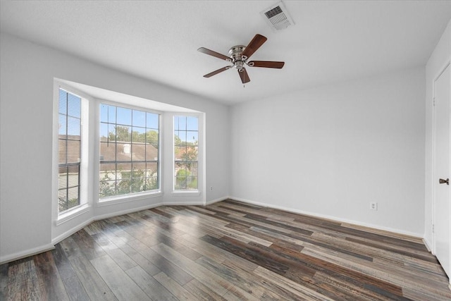 unfurnished room featuring ceiling fan and dark hardwood / wood-style floors