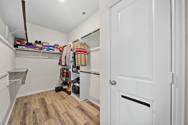 walk in closet featuring light hardwood / wood-style flooring