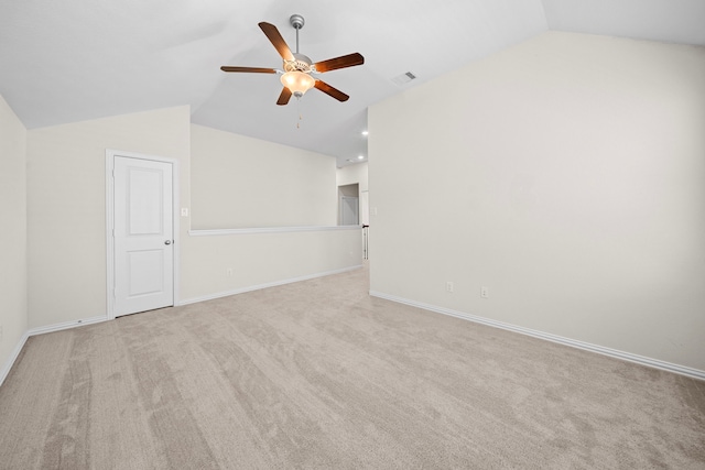 empty room featuring ceiling fan, light colored carpet, and lofted ceiling