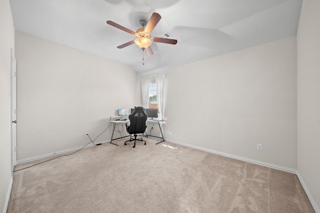 unfurnished office with lofted ceiling, ceiling fan, and light colored carpet