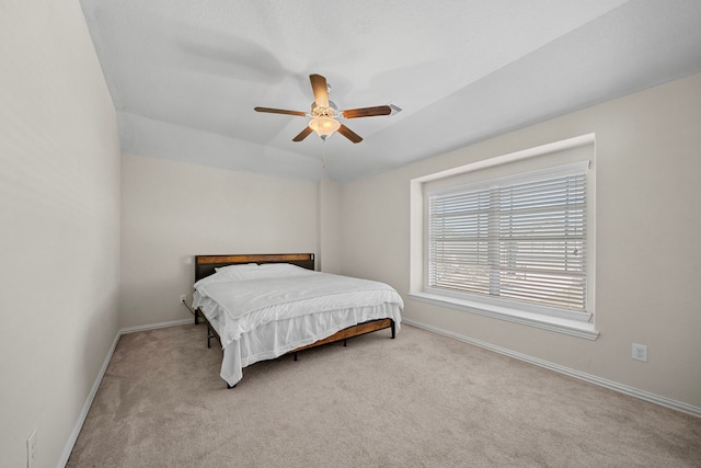 bedroom with ceiling fan and light colored carpet