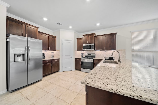 kitchen featuring stainless steel appliances, sink, light stone counters, tasteful backsplash, and crown molding