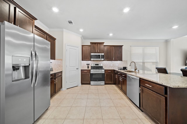 kitchen featuring sink, backsplash, crown molding, and appliances with stainless steel finishes