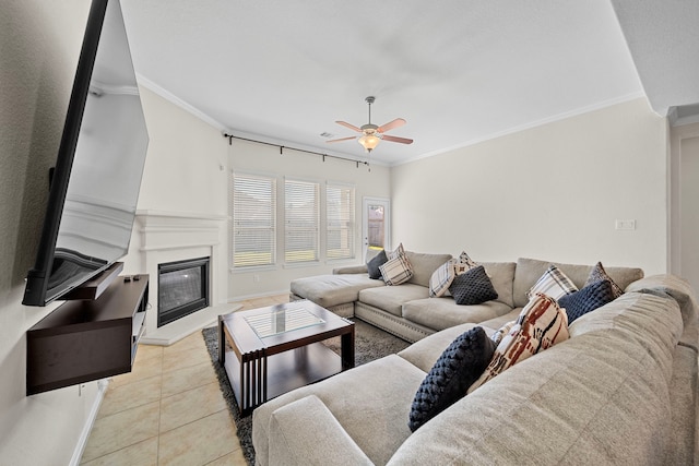 living room with light tile patterned floors, ceiling fan, and crown molding