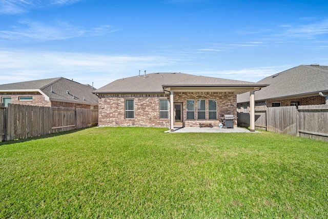 back of property featuring a patio area and a yard