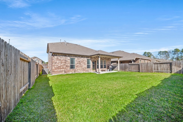 rear view of property with a lawn and a patio