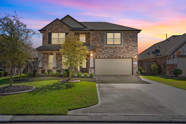 view of front of property with a lawn and a garage